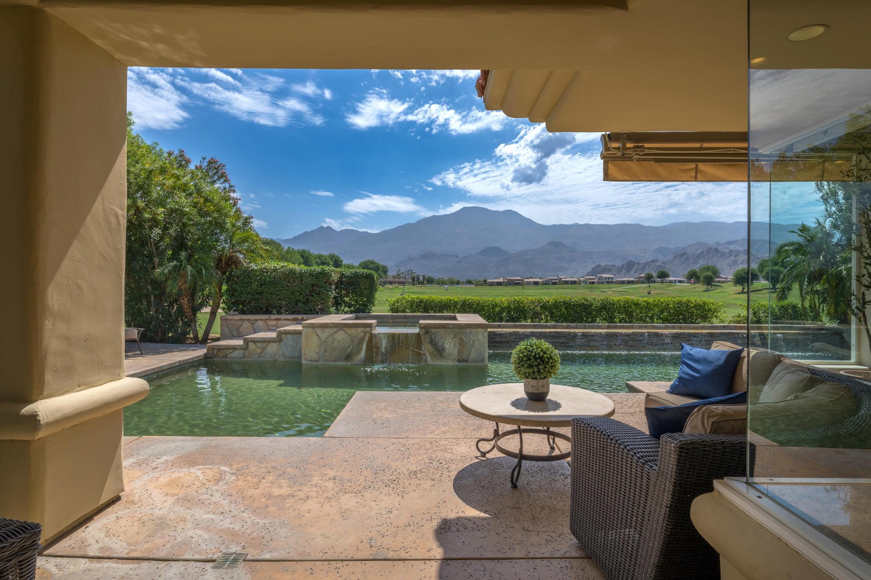 a view of a lake with couches in the patio