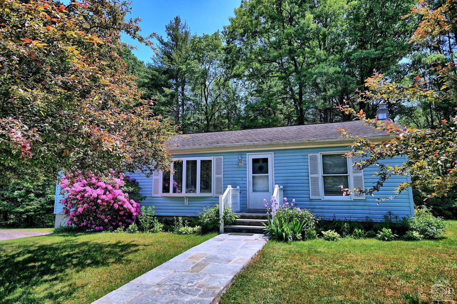 a front view of a house with garden