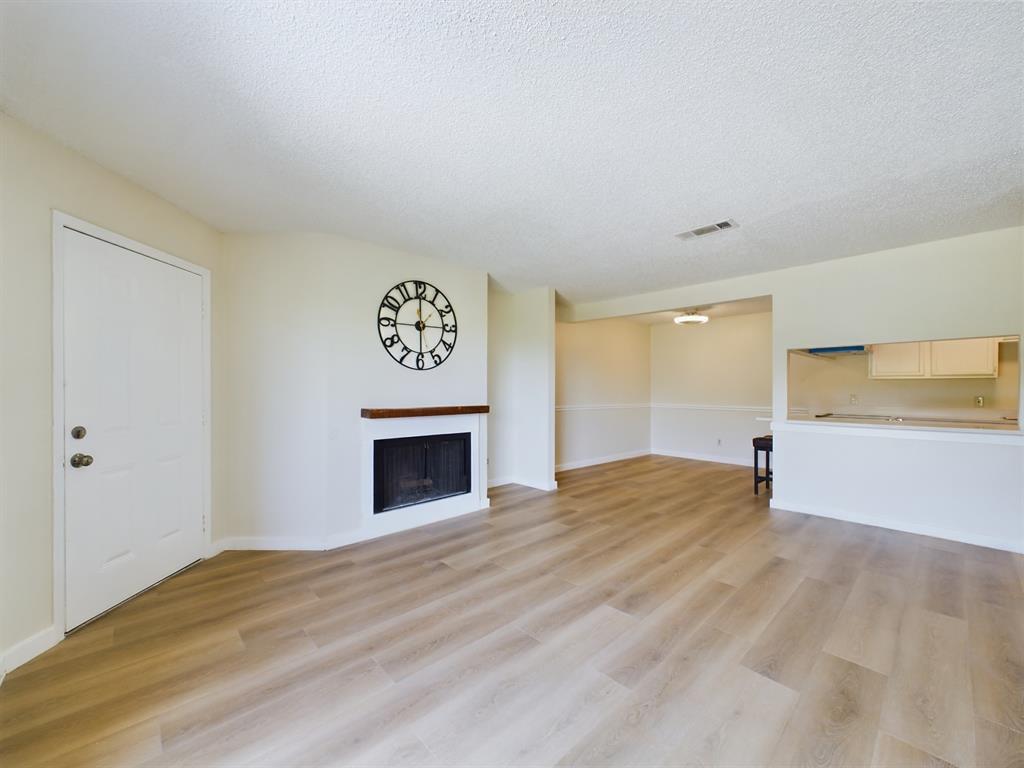 a view of empty room with a fireplace