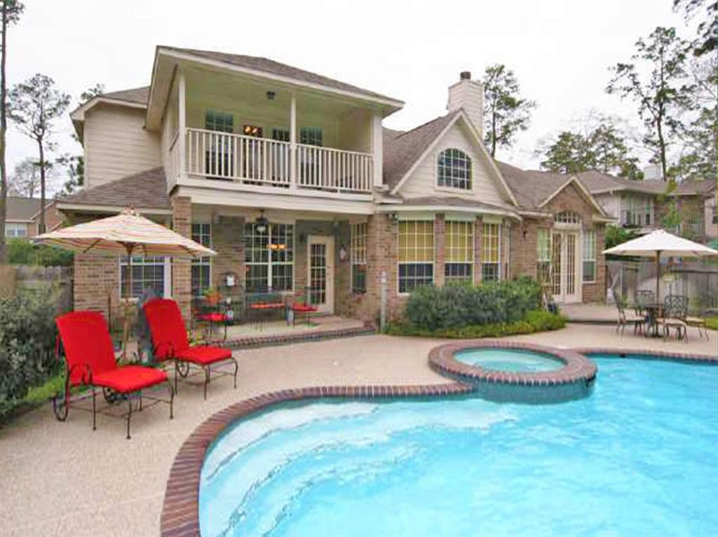 a view of a house with swimming pool and sitting area