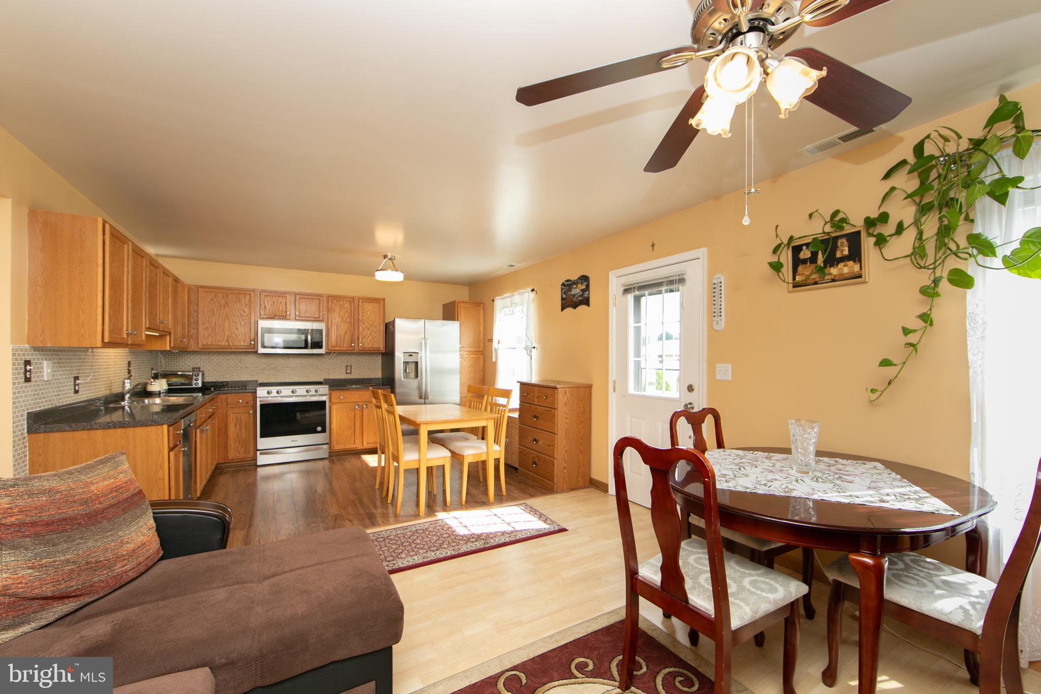 a view of a dining room with furniture and wooden floor