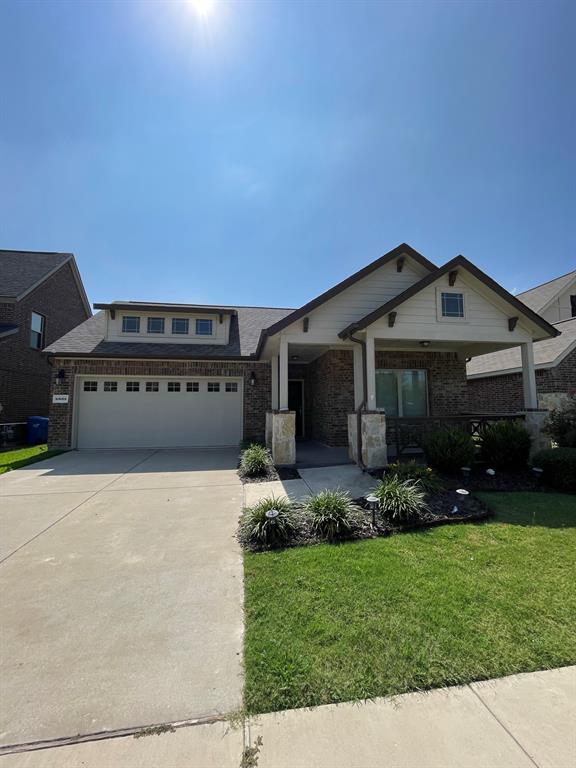 a front view of a house with a garden and yard