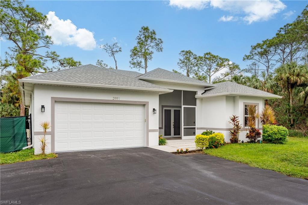 View of front facade with a front lawn and a garage