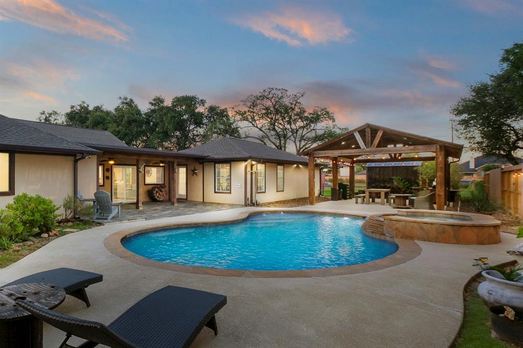 swimming pool view with a seating space