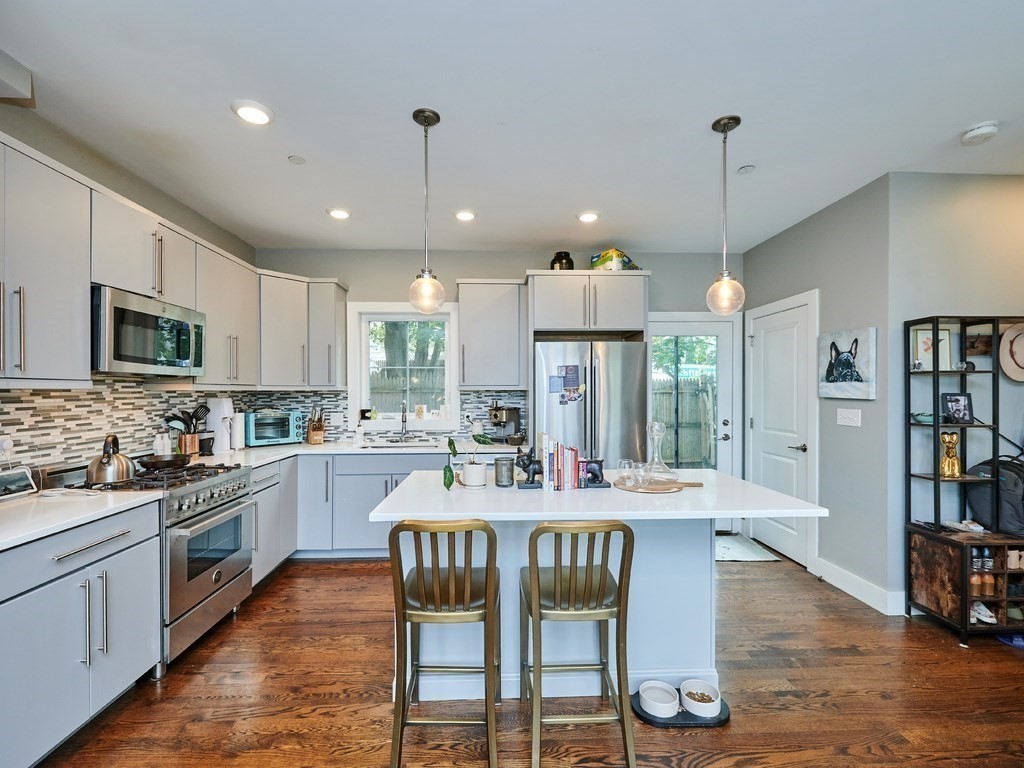 a large kitchen with a table and chairs