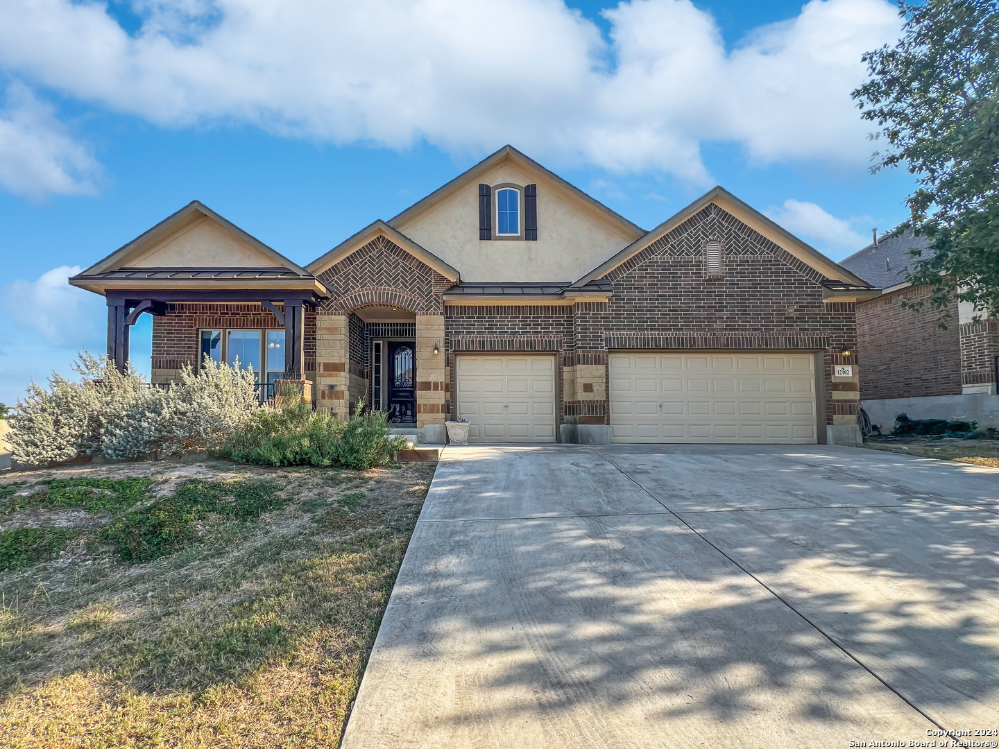 a front view of a house with a yard and garage