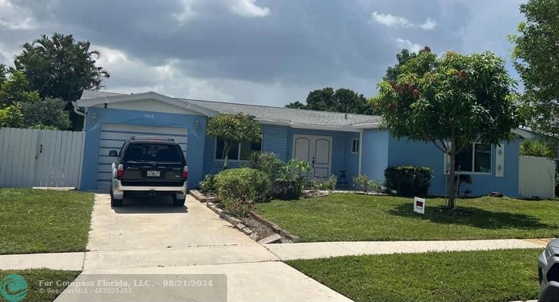 a front view of a house with a yard and a garage