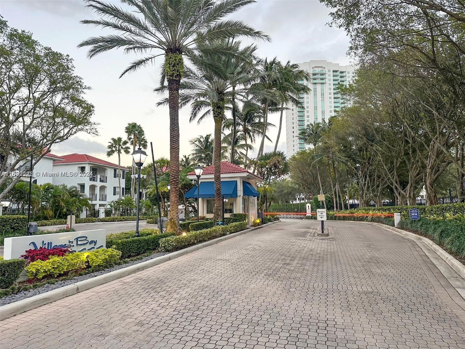 a view of a street with a building and trees in the background