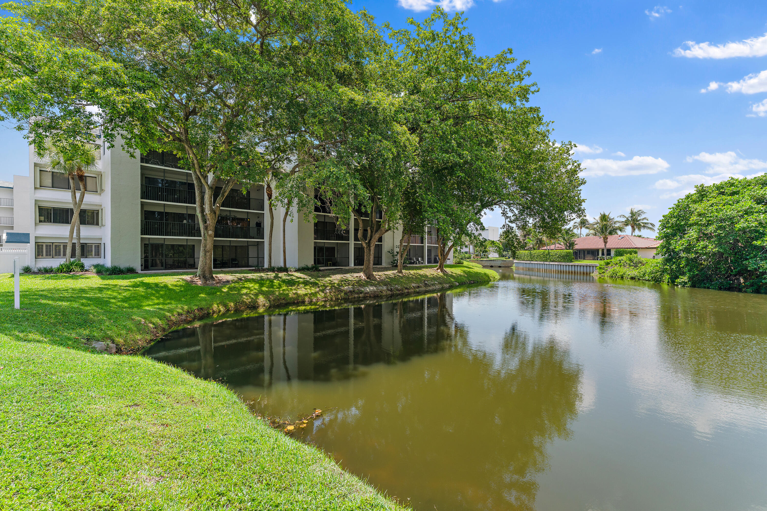 a view of house with swimming pool and lake view