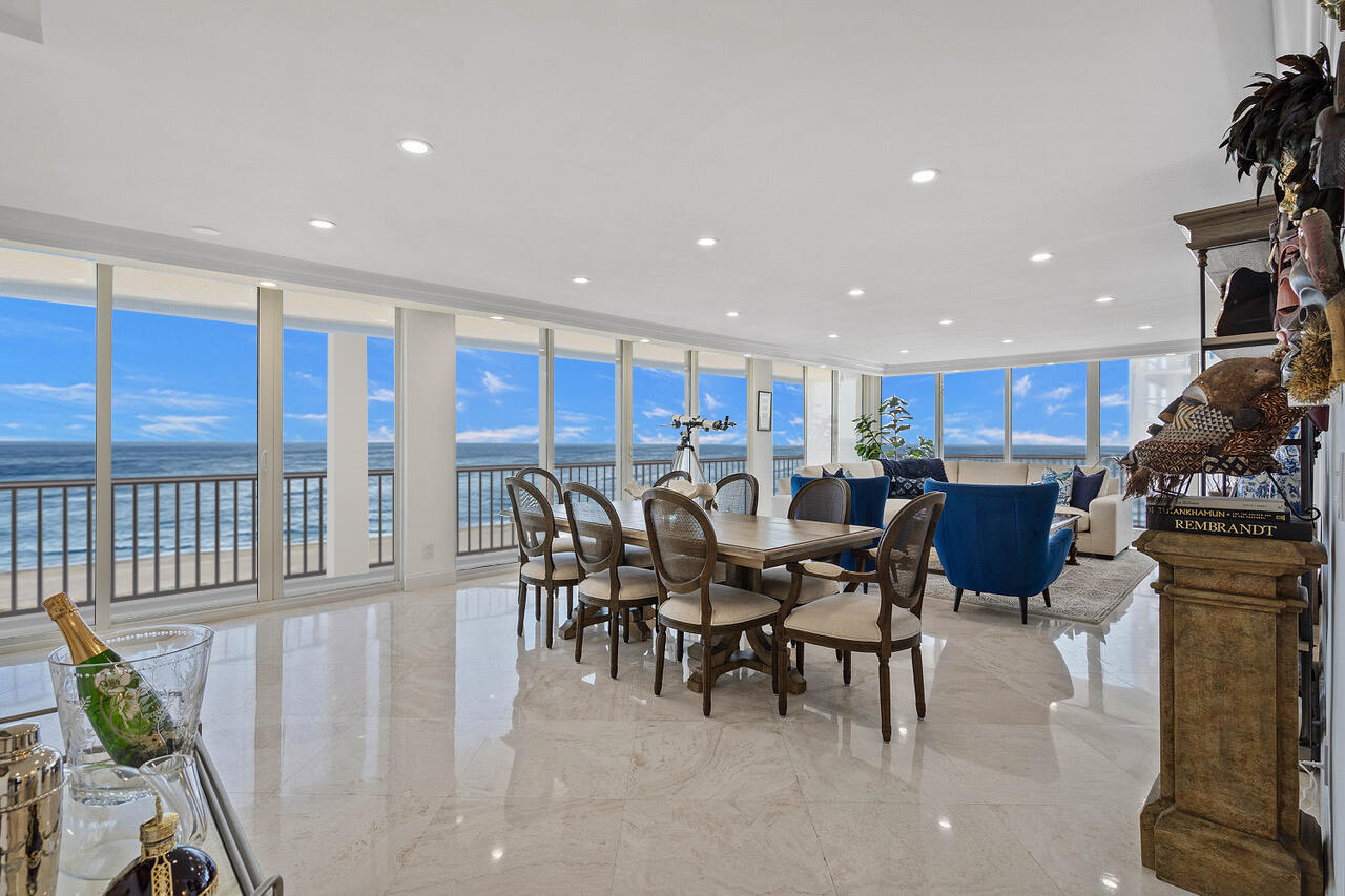 a kitchen with a dining table chairs and white cabinets