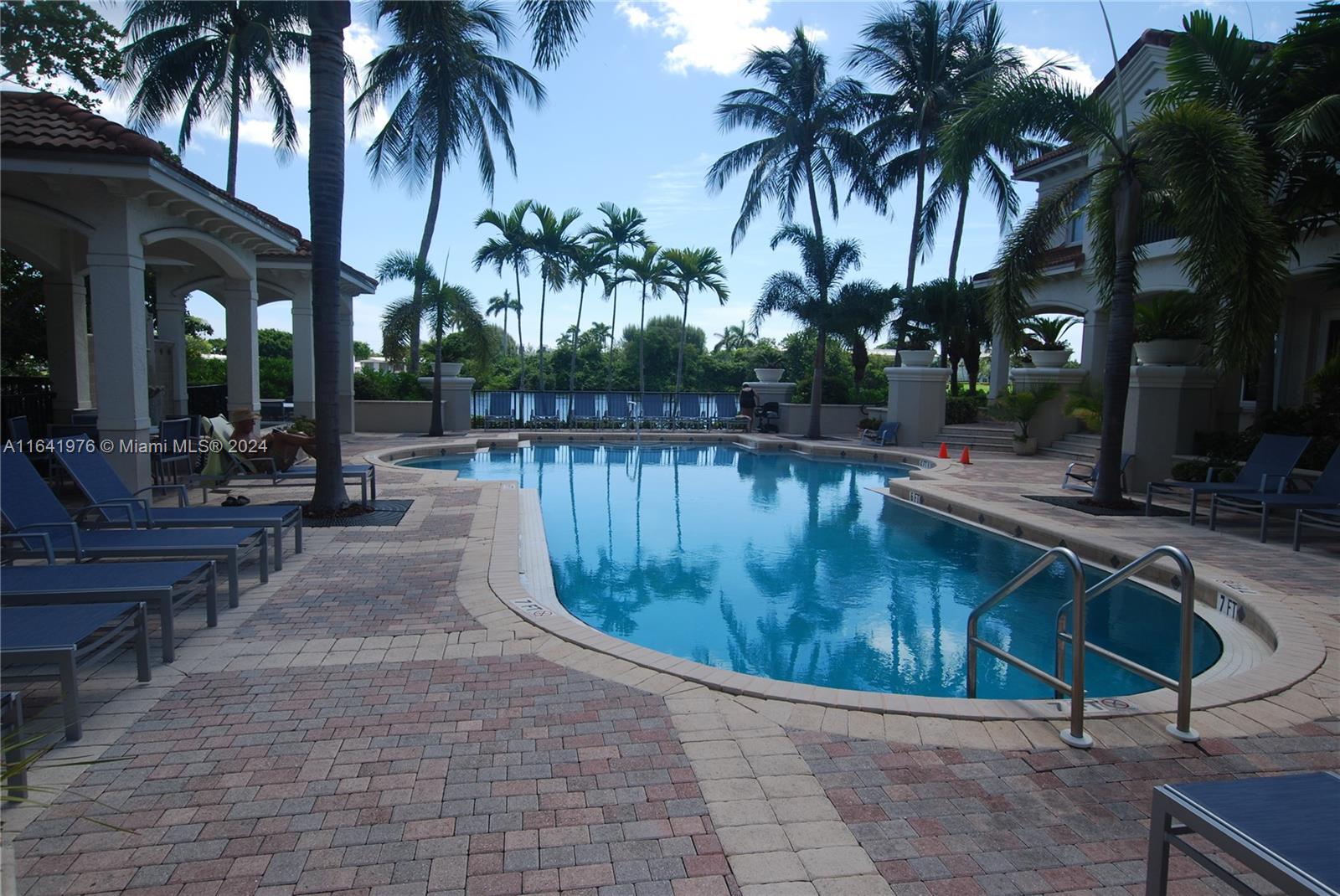 a swimming pool with outdoor seating