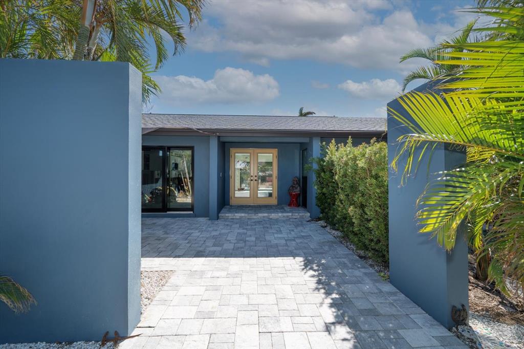 a view of a front door and a yard