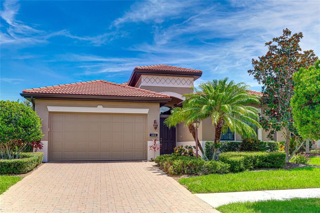 Beautiful curb appeal with lush landscaping two car garage and double door entry with transom window to let in natural light.