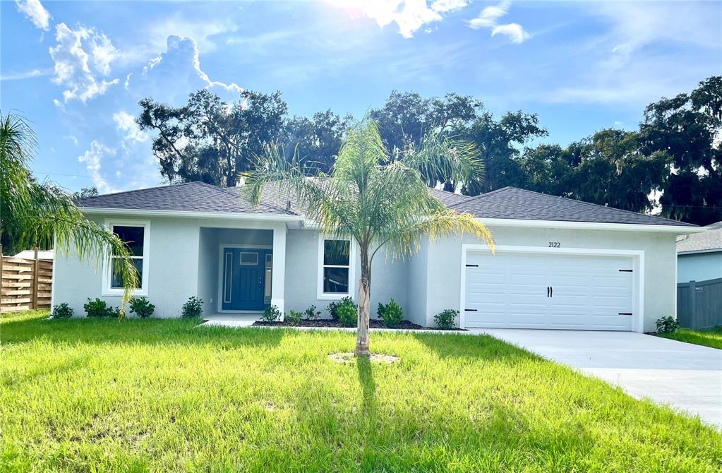 a view of a house with yard and tree s