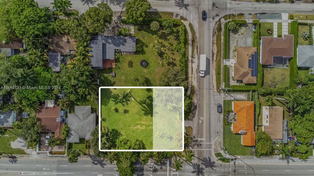 an aerial view of a residential houses with yard