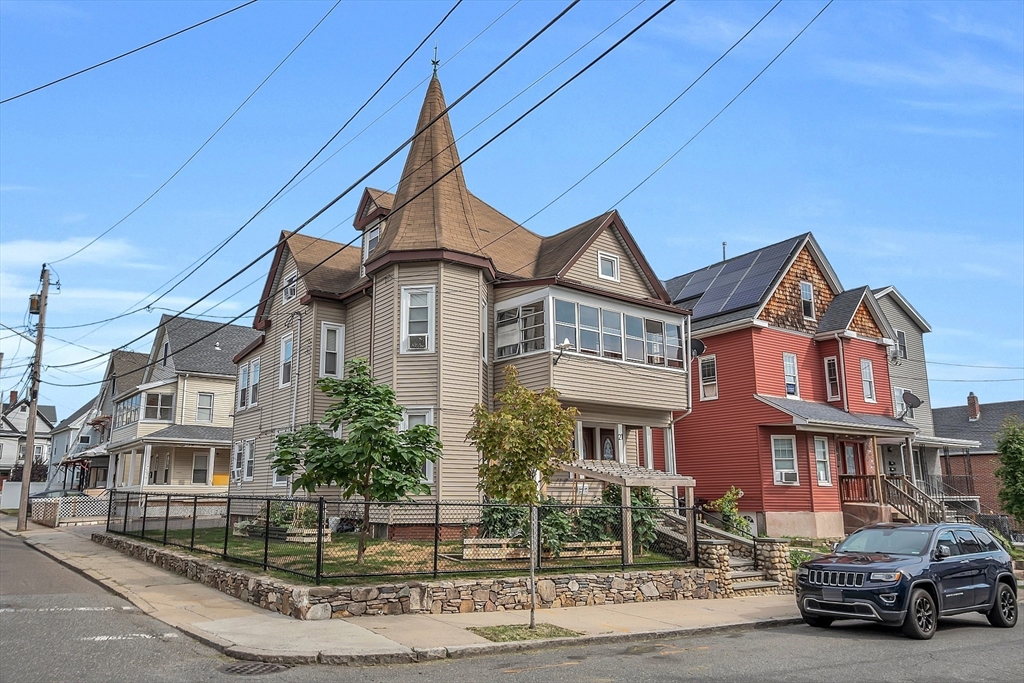 a front view of a residential apartment building with a yard