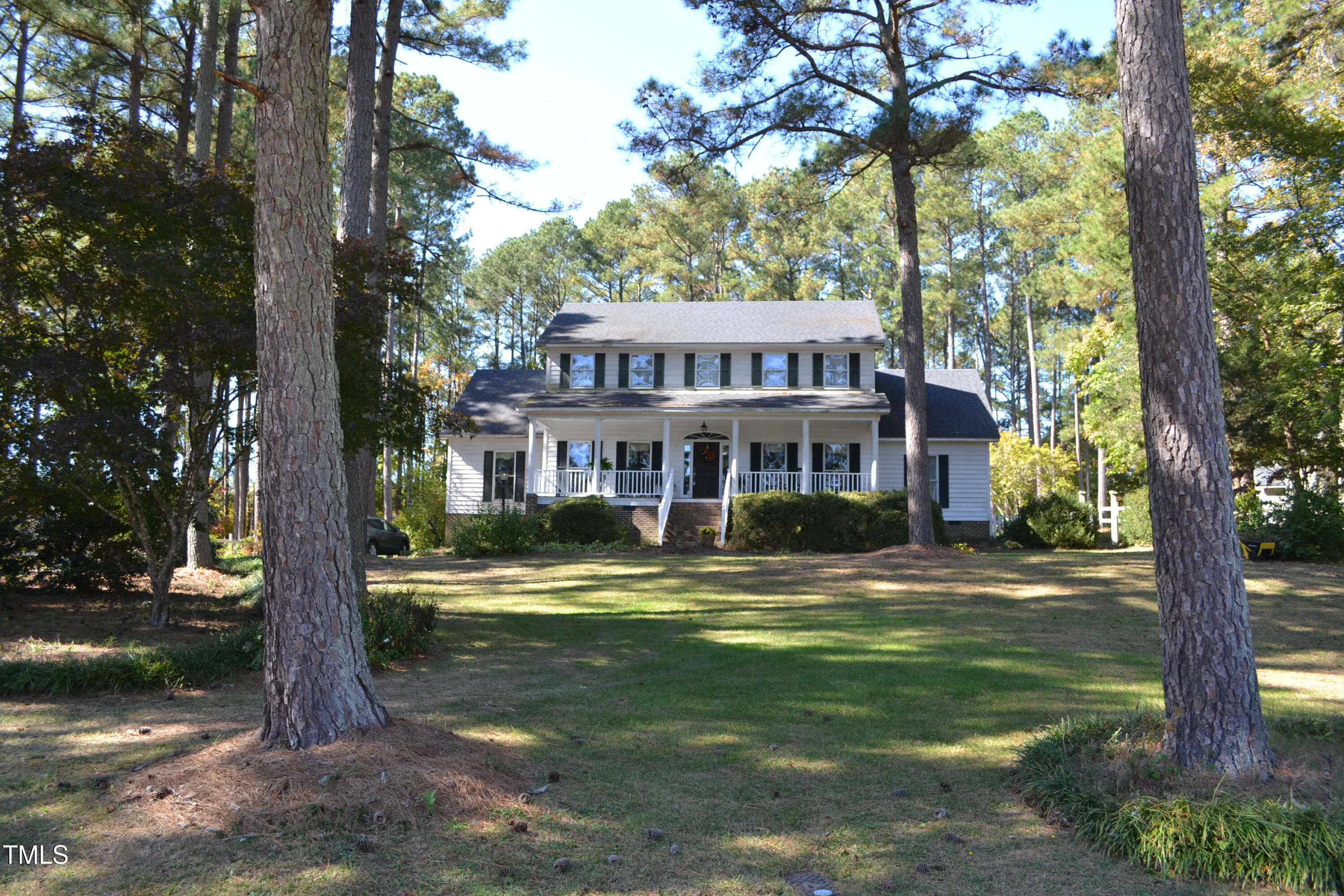 a front view of a house with a yard table and chairs