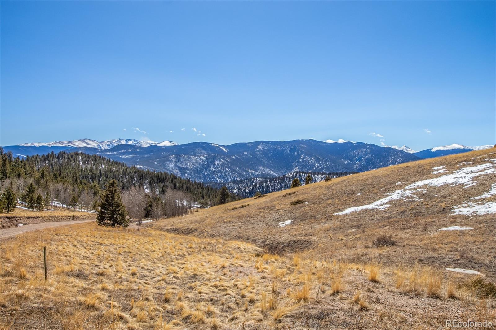 a view of a road with mountains in the background