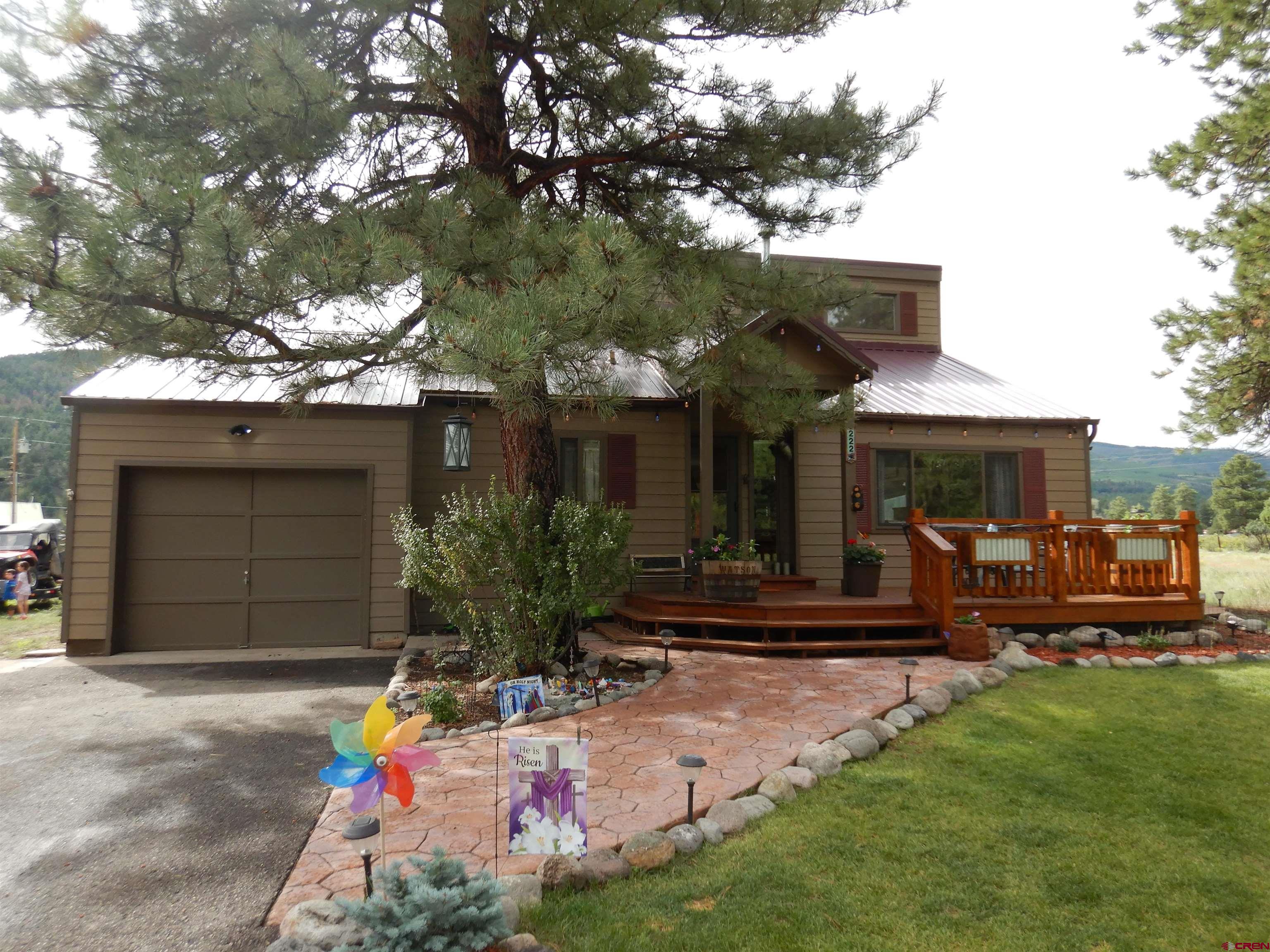 a front view of a house with porch and garden