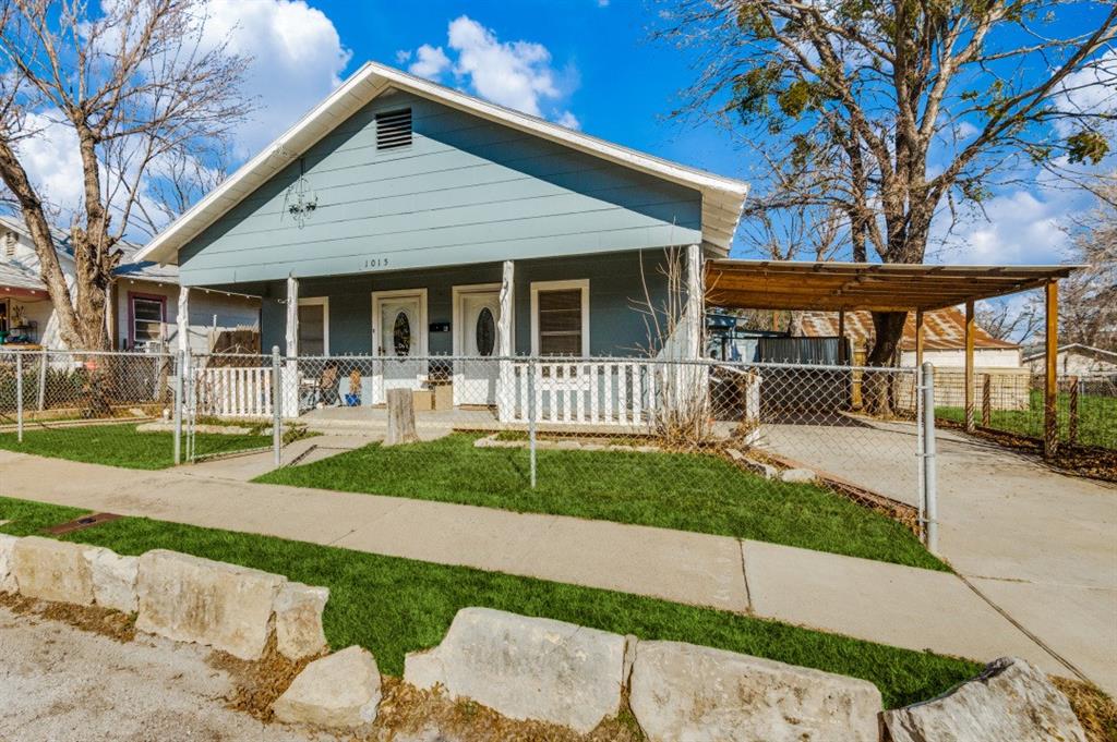 a front view of a house with a yard and porch