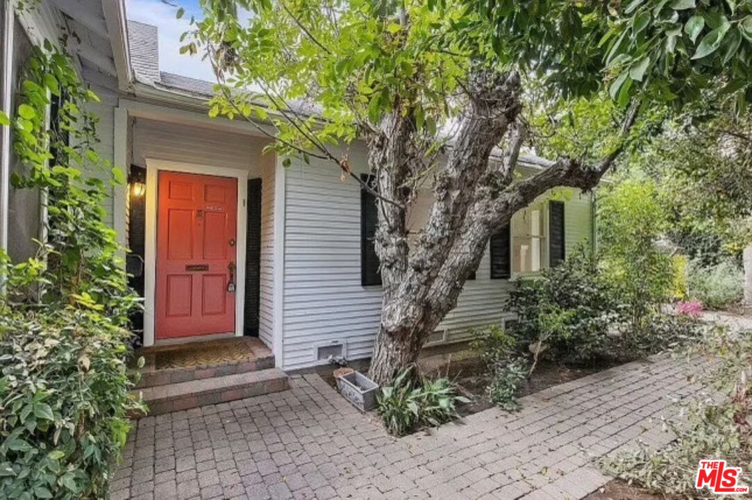 a house that has a tree in front of the house