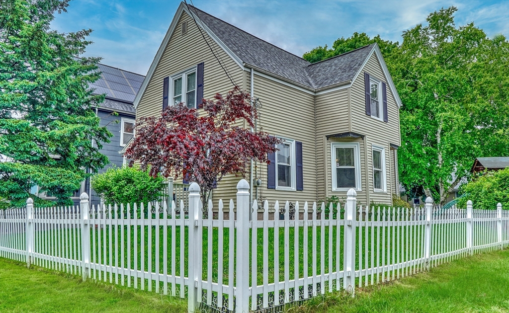 a front view of a house with a garden