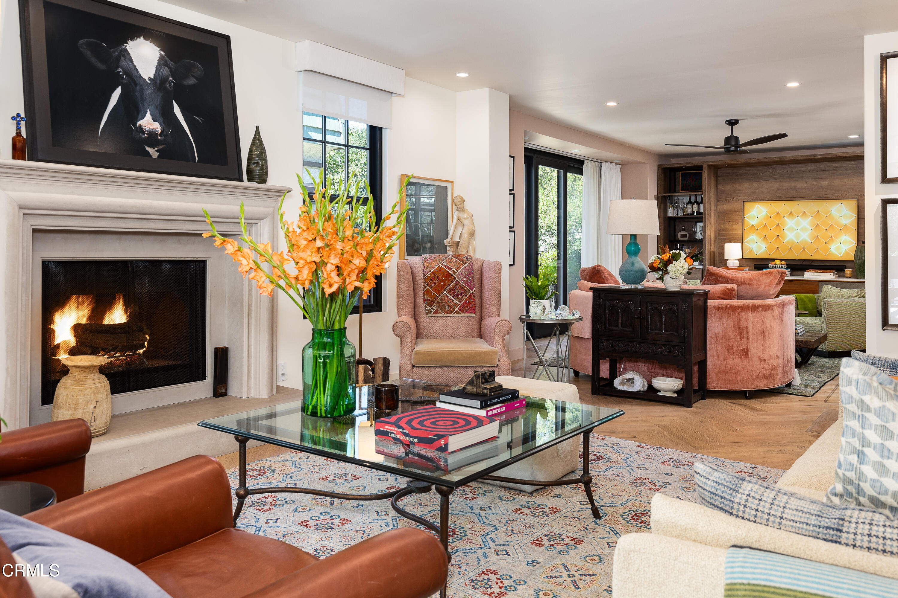 a living room with furniture a fireplace and a window