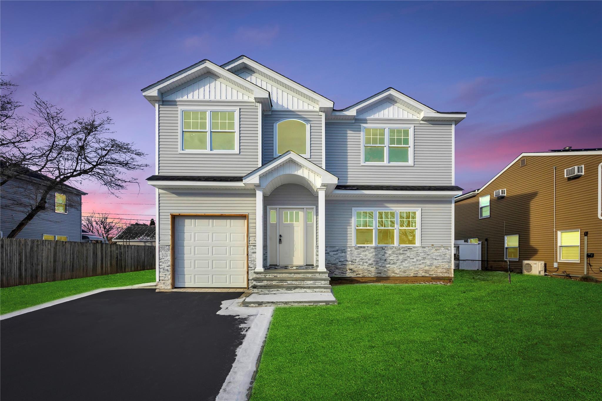 Craftsman-style house with ac unit, a garage, and a yard