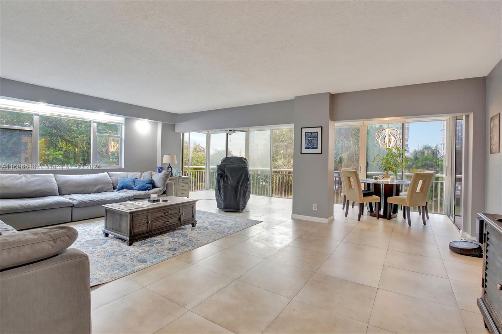 a living room with furniture and large windows