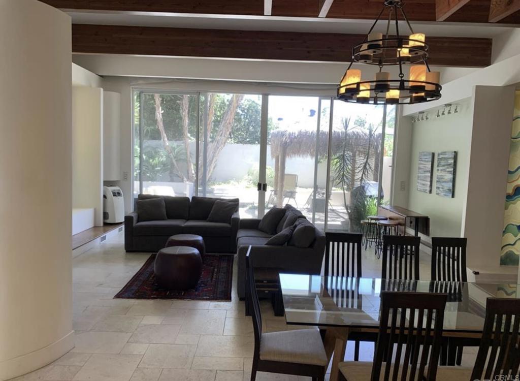 a living room with furniture and a floor to ceiling window