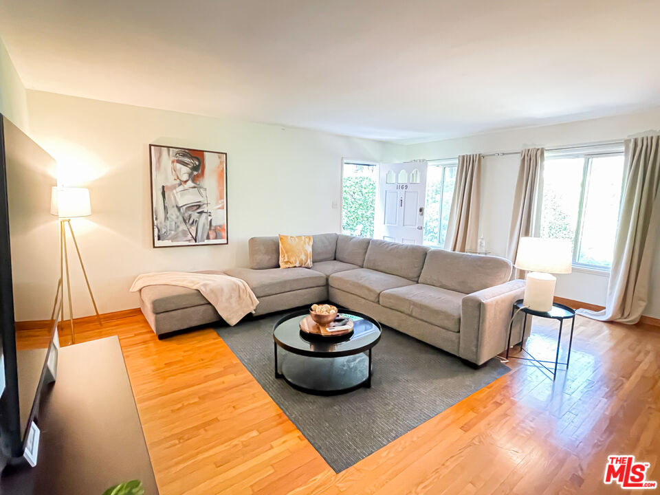 a living room with furniture and a large window