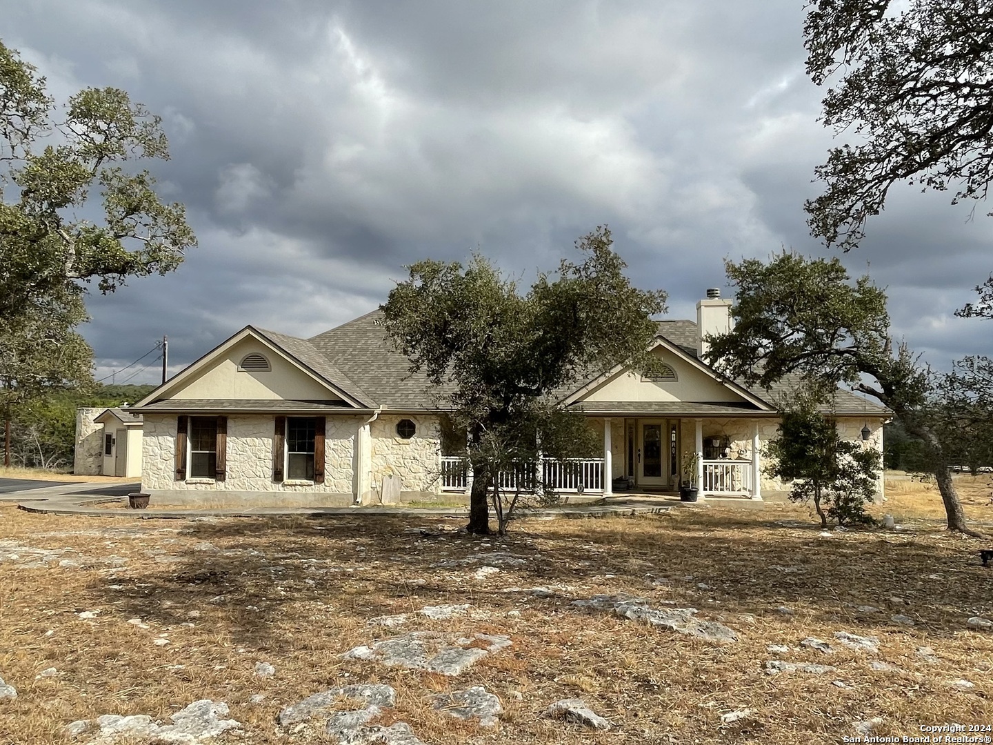 a front view of a house with a garden