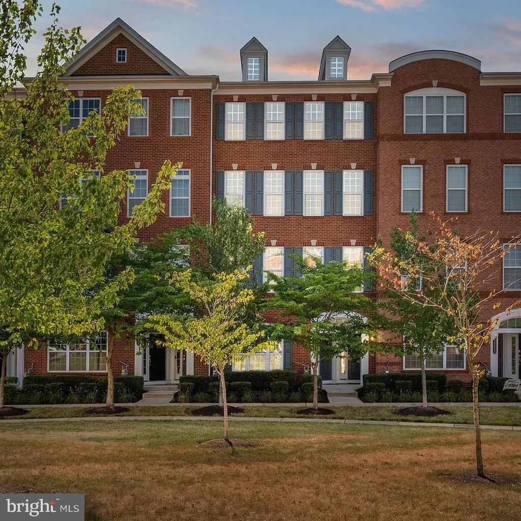 a front view of a building and trees