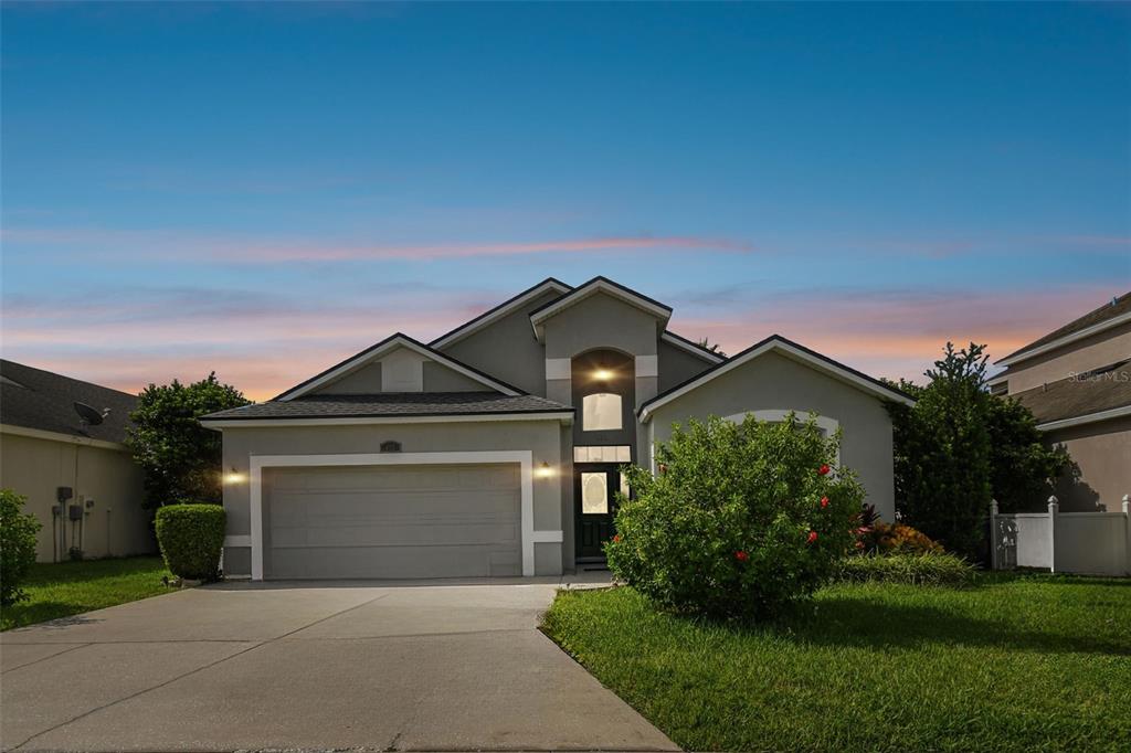 a front view of a house with a yard and garage