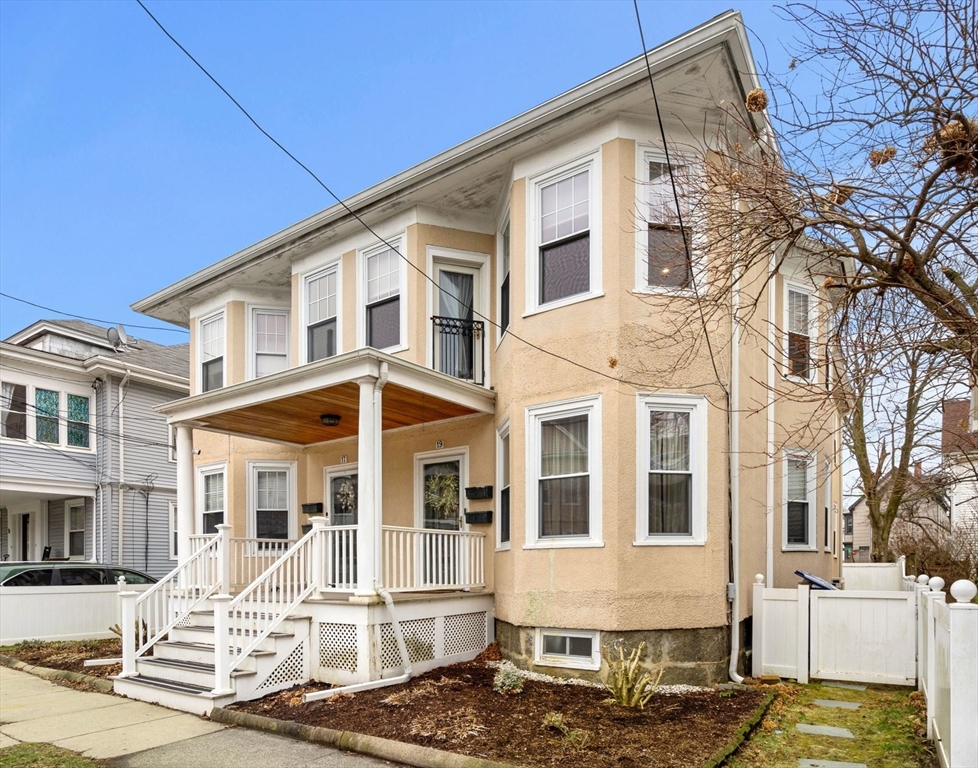 a front view of a residential apartment building with a yard