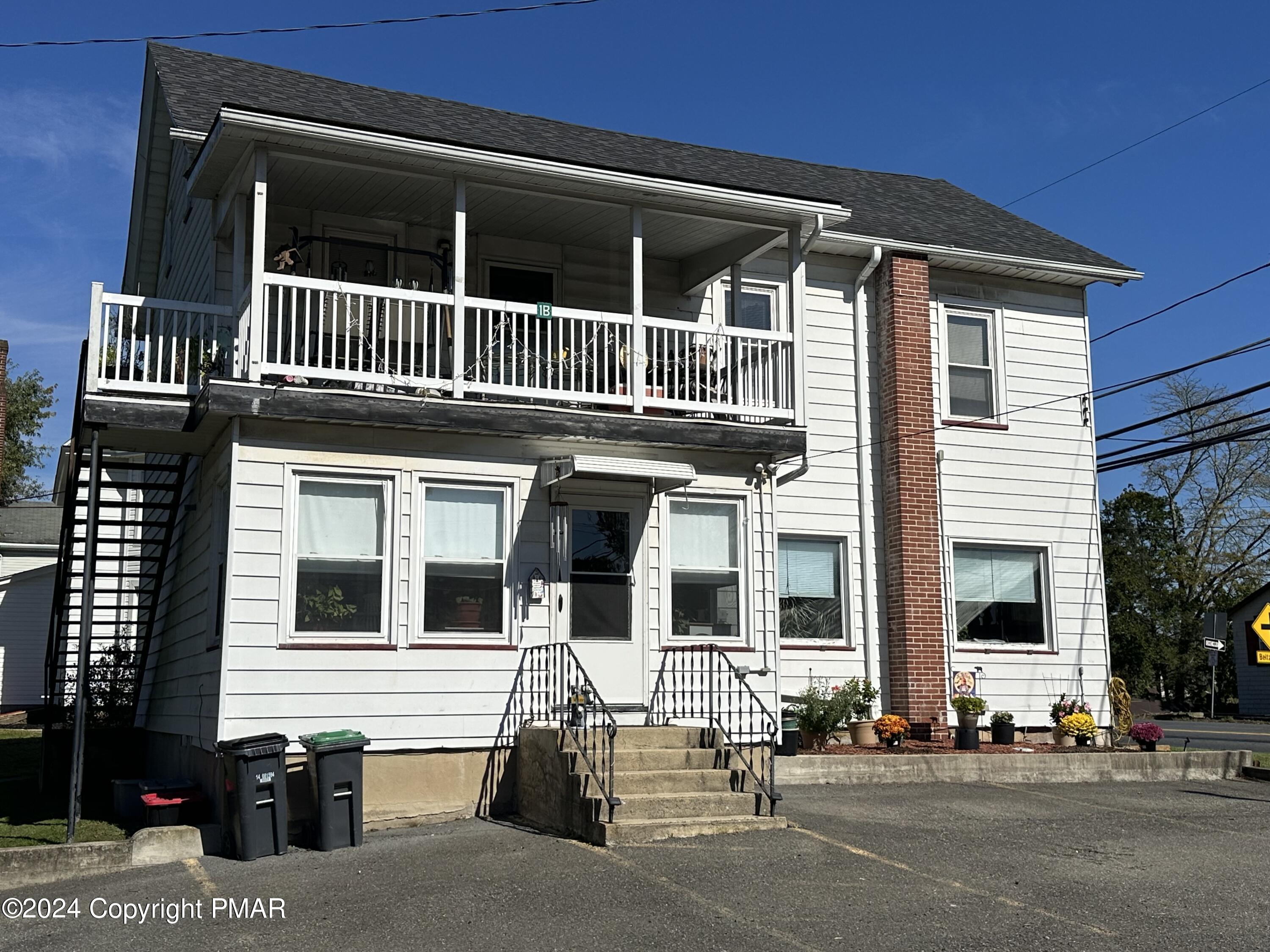 a front view of a house with a parking space