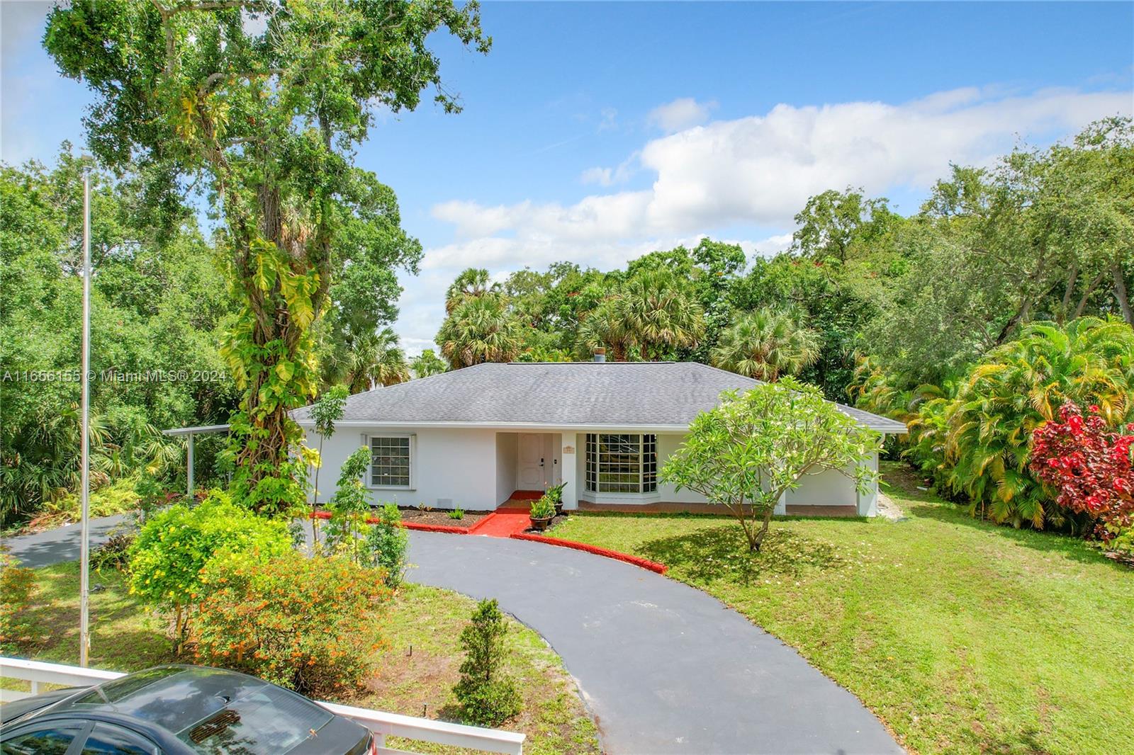 a front view of house with yard swimming pool and green space