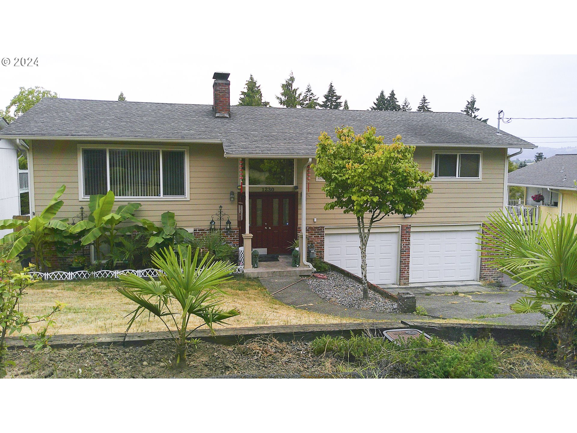 a view of house with yard and outdoor seating