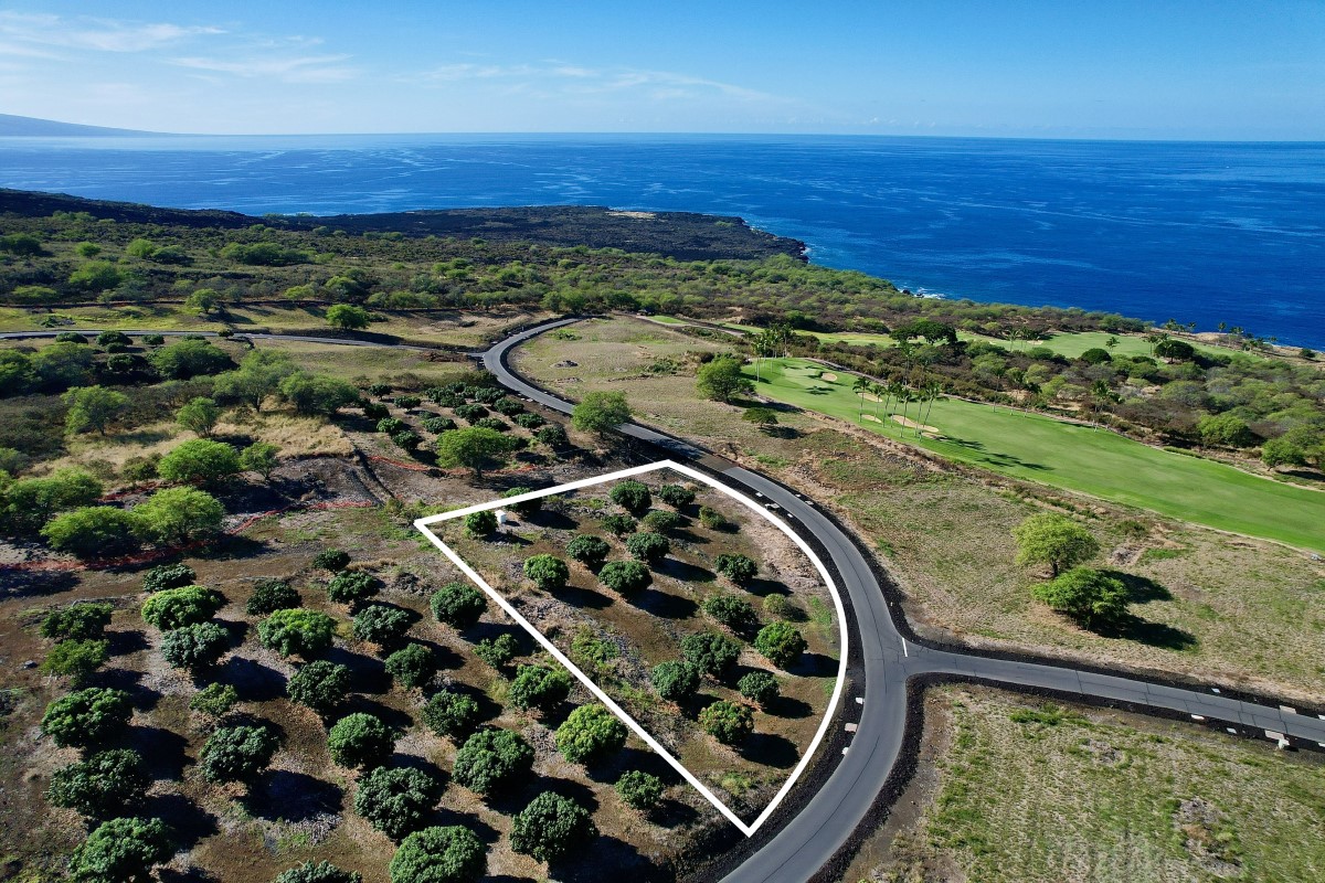 an aerial view of a golf course with parking space