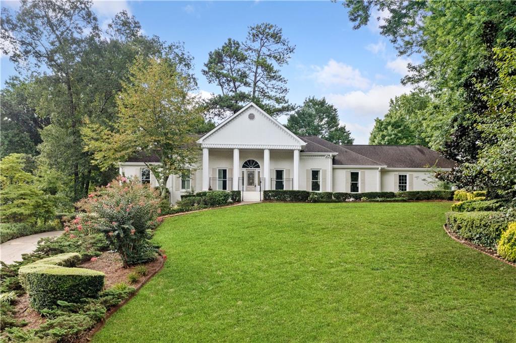 a front view of a house with a garden