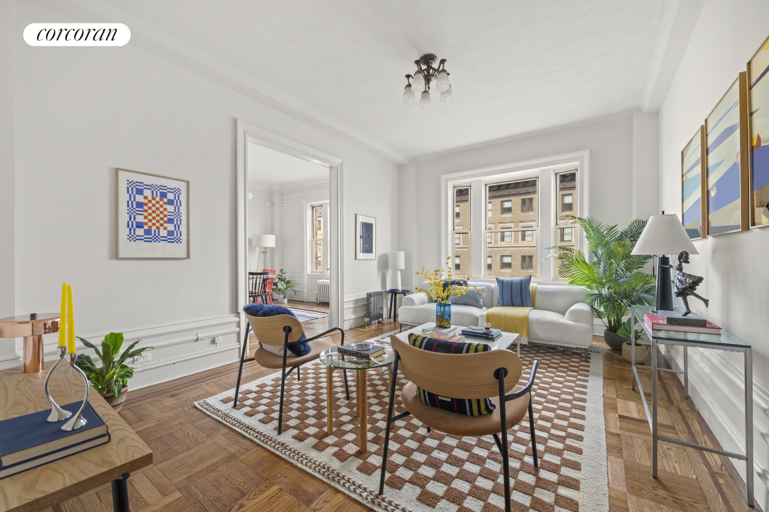 a living room with furniture potted plant and window