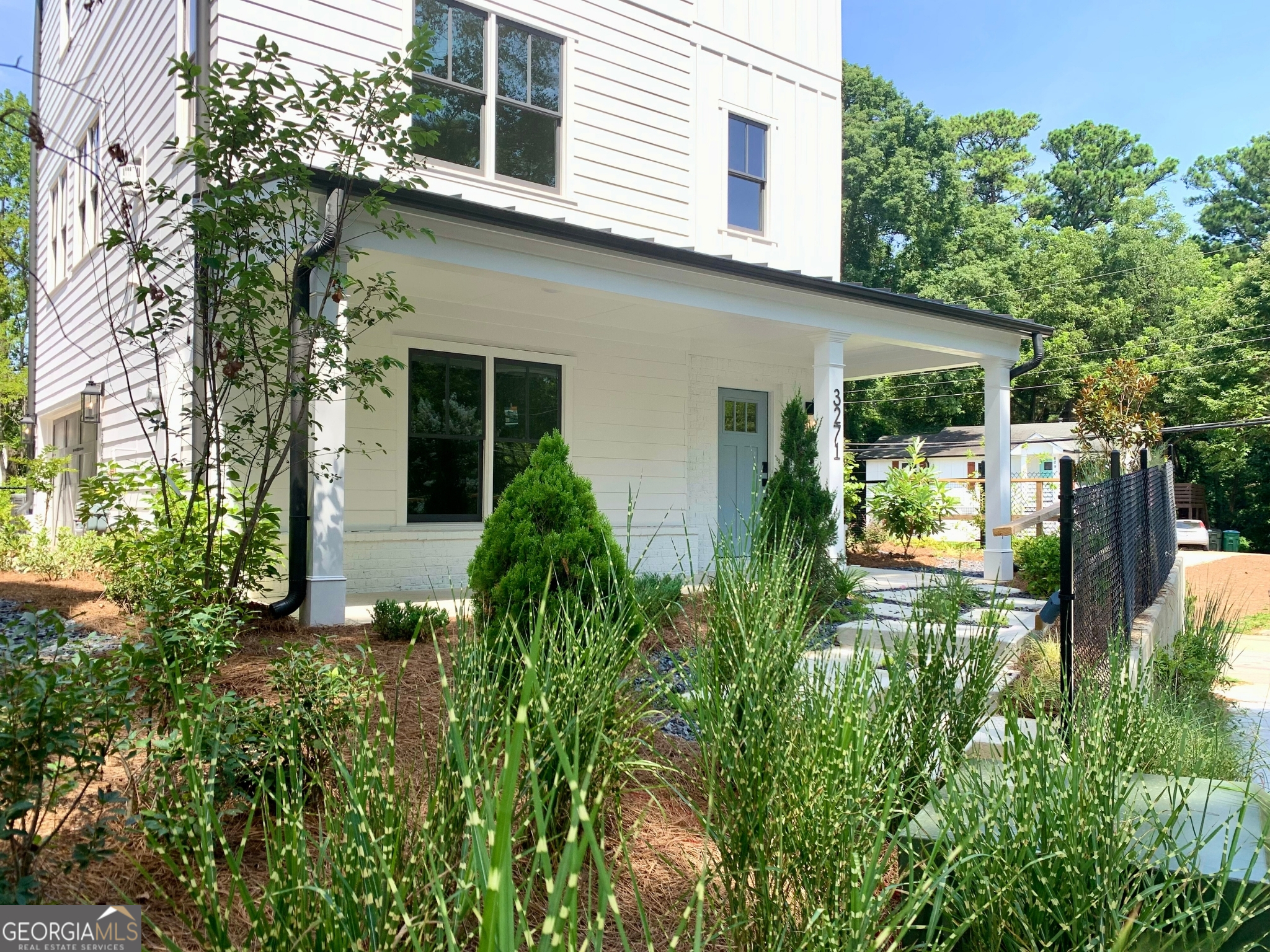 a view of house with backyard and sitting area