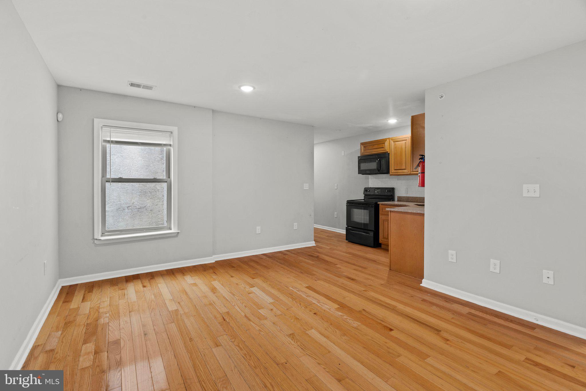 a view of a kitchen with microwave and cabinets