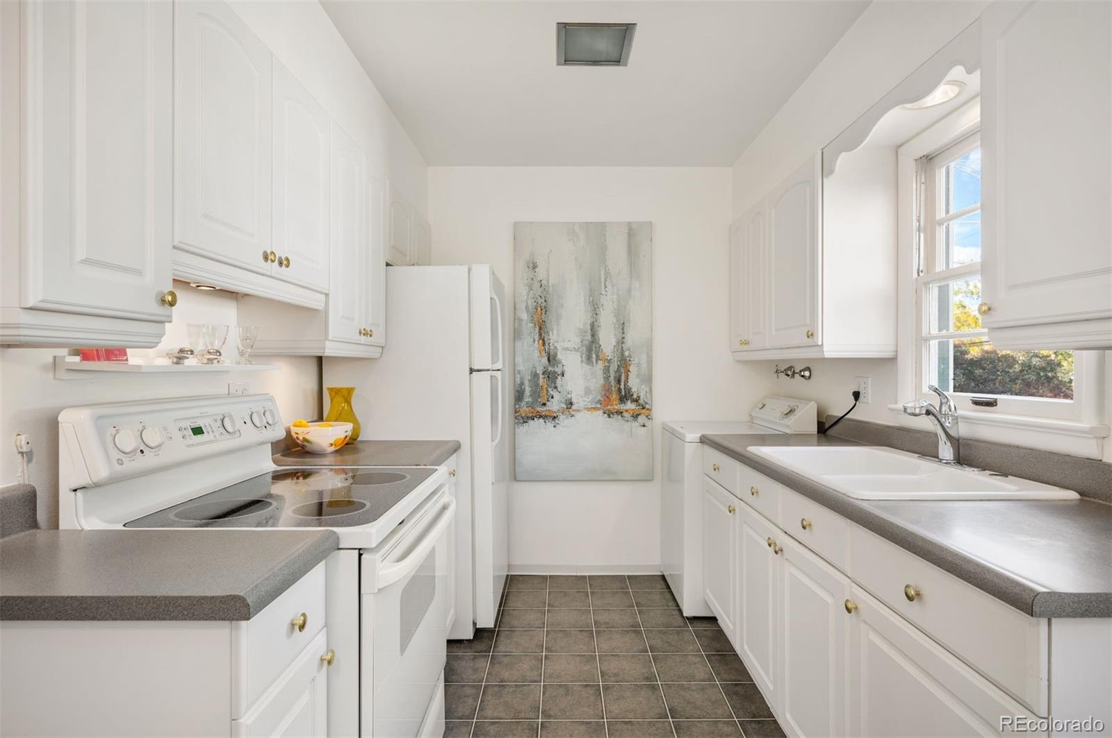 a kitchen with a sink a stove and cabinets