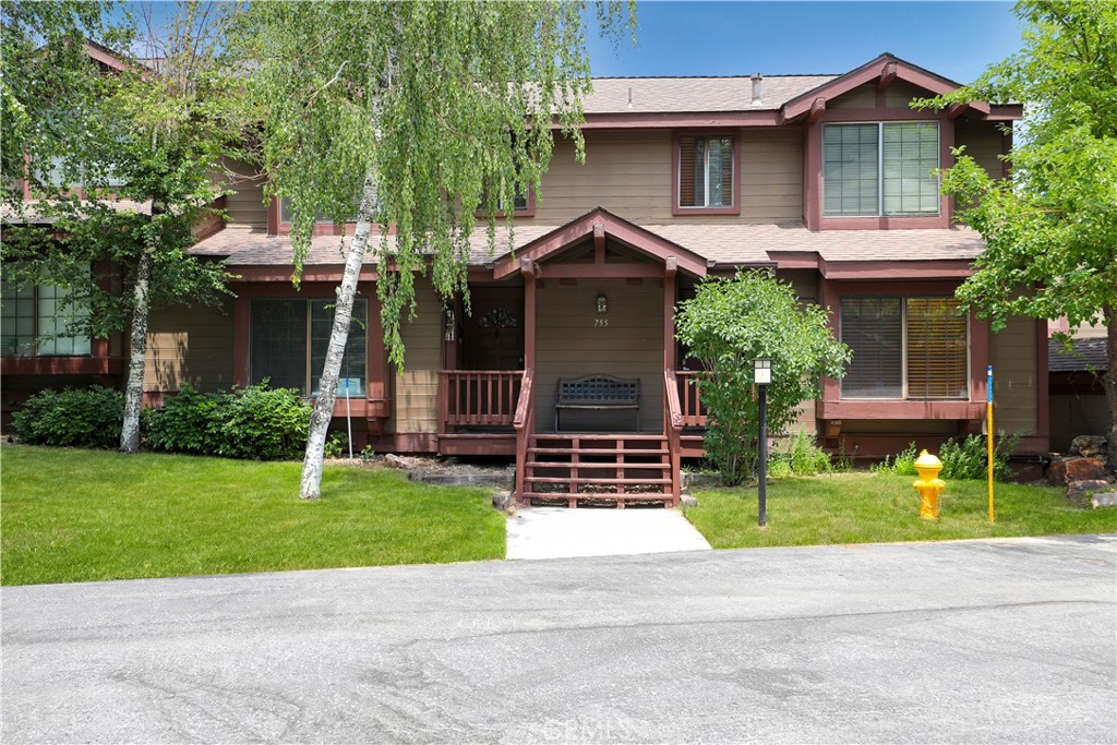 a front view of a house with a garden and plants