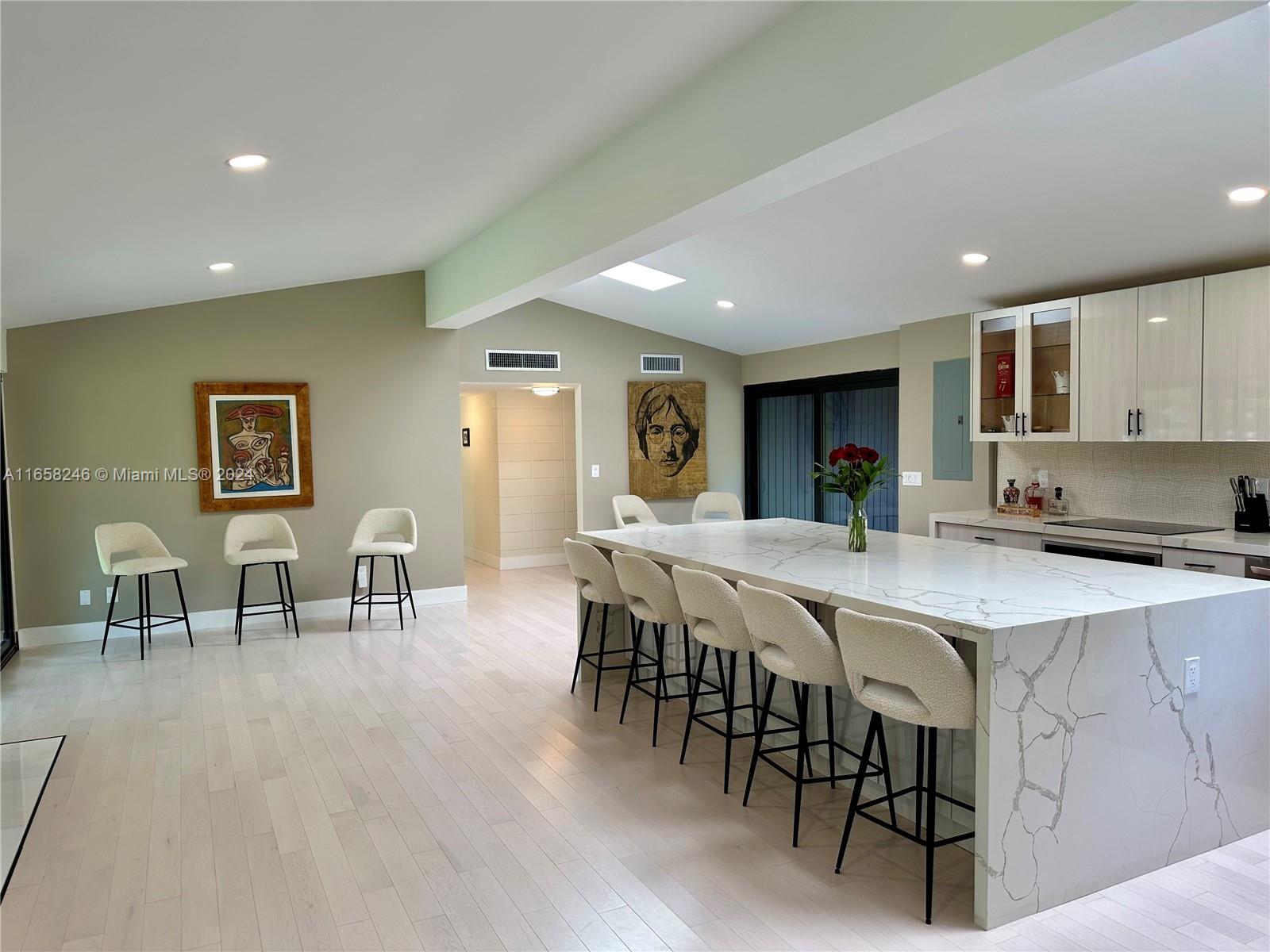 a large kitchen with a table and chairs