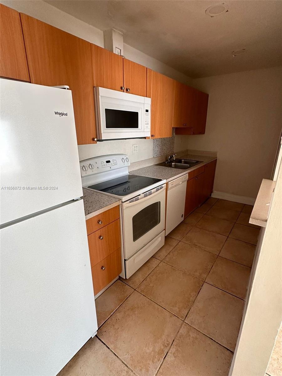 a kitchen with a stove top oven and cabinets