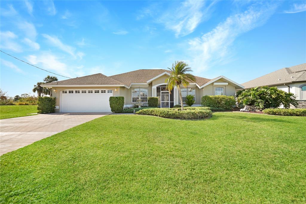 a front view of a house with a garden and yard