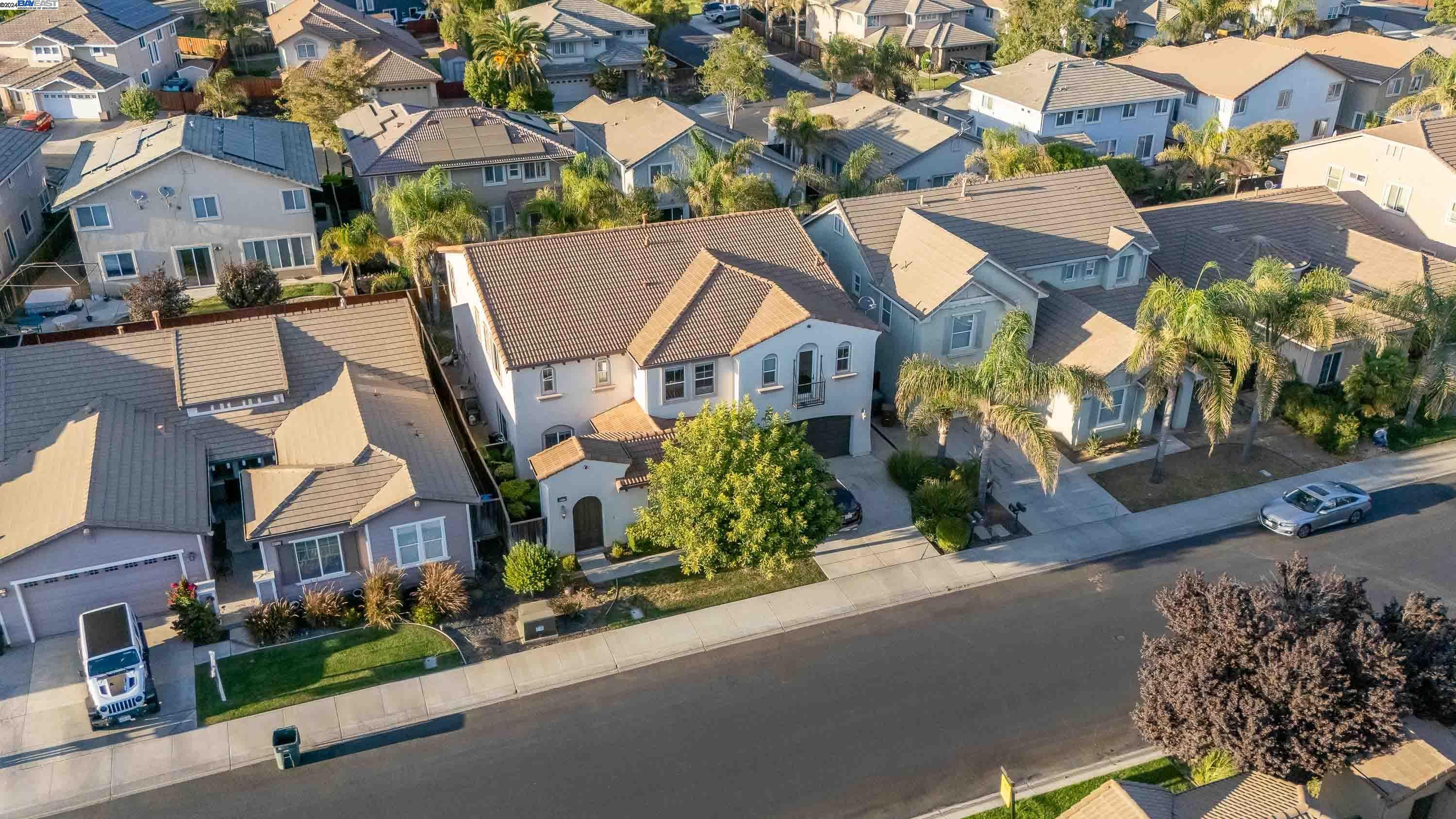 an aerial view of multiple houses with a street