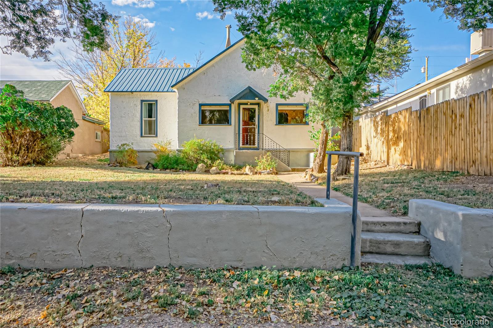 a front view of a house with a garden and outdoor seating